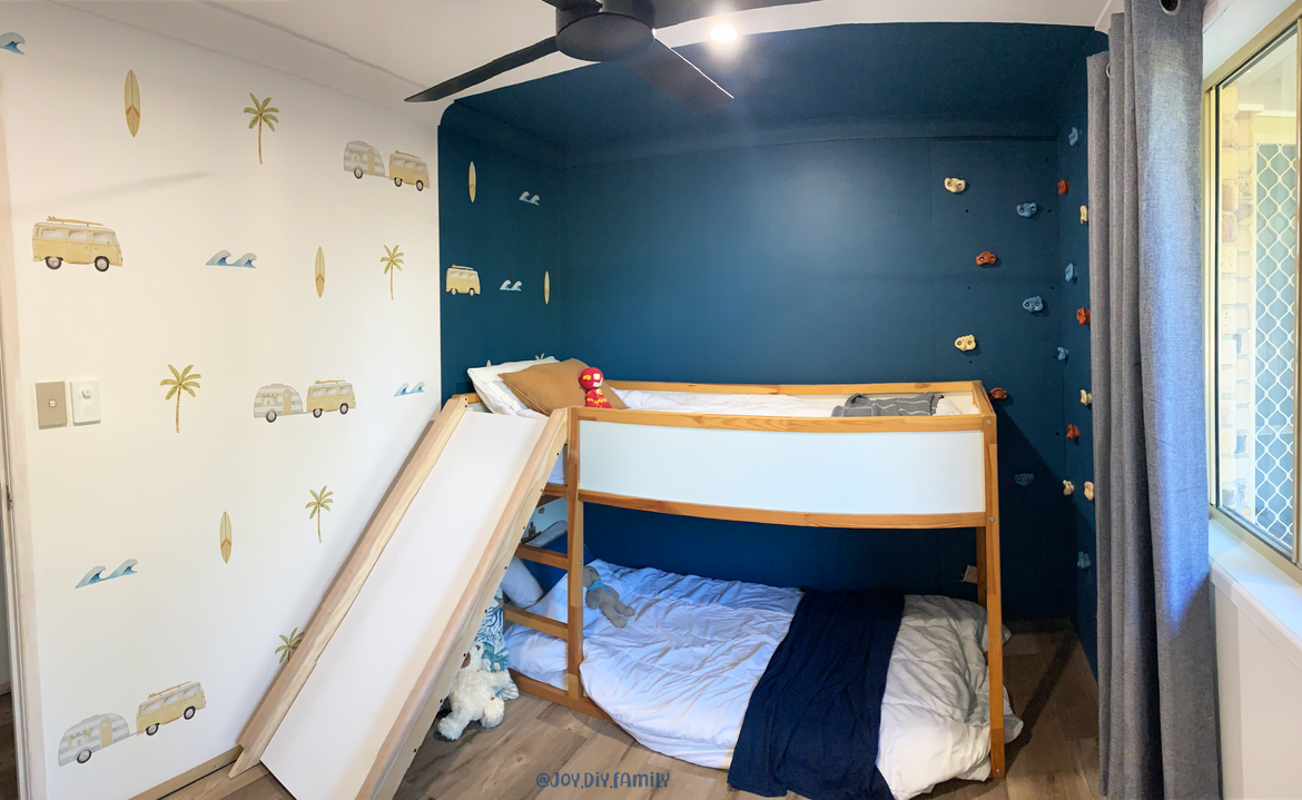 Boys bedroom with a slide and a climbing wall