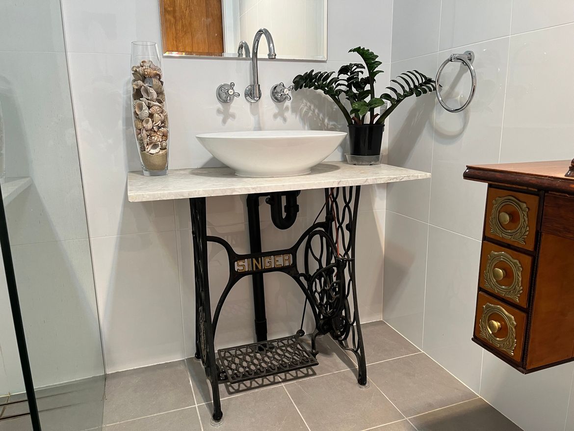 Basin installed on restored treadle base and recycled marble piece