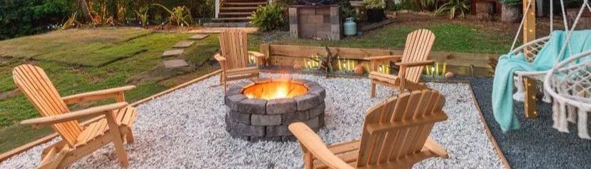 Outdoor fire pit area with hanging chairs.jpeg