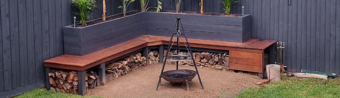 Fire pit area with planter box and bench seat.jpeg