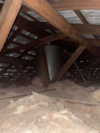 Gravity fed water tank in the ceiling