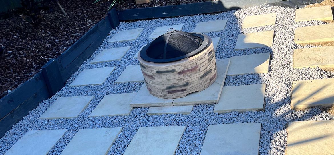 Fire pit area with pavers and stones.jpeg