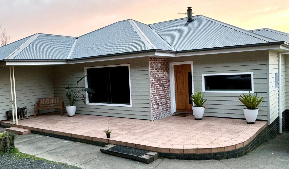 Weatherboard cladding over brick veneer home.jpg