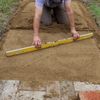 5.2 Use a screed bar to smooth and level the surface.jpg