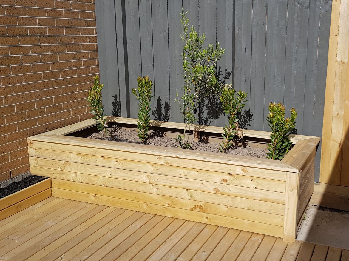 Planter boxes clad with timber decking boards