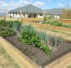 Timber sleepers are commonly used for raised garden beds